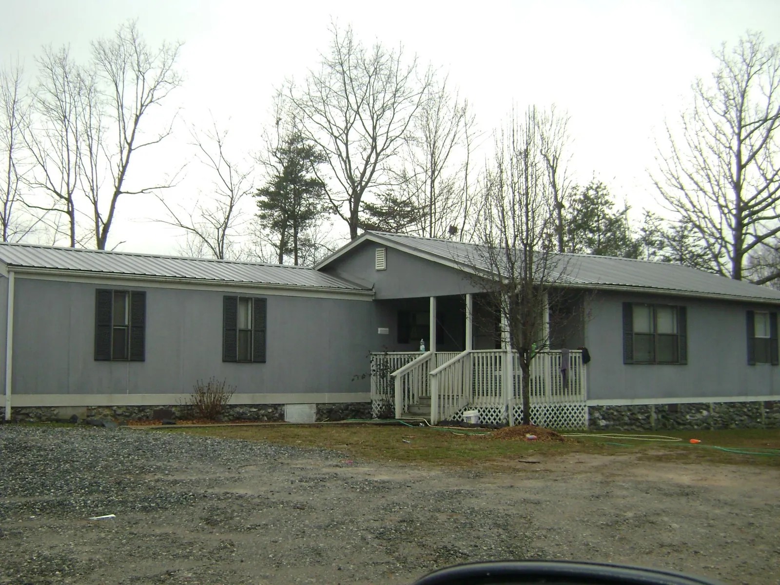 Metal roof over a manufactured home with a covered front porch in Register